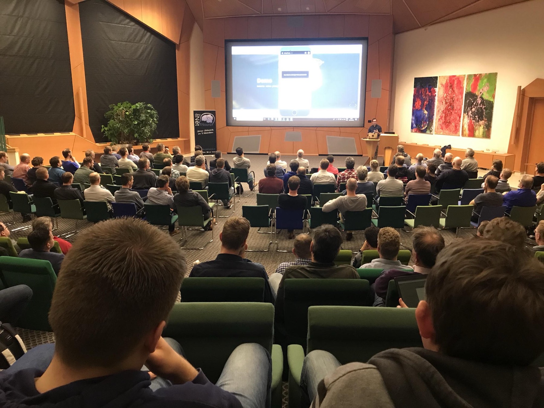 A community audience watching Henk present