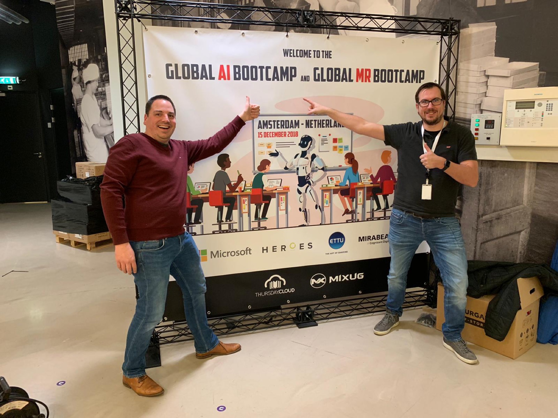 Two Global AI Bootcamp organizers celebrating together in Amsterdam